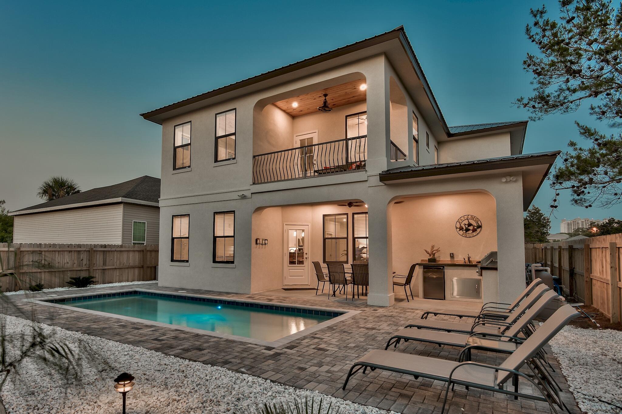 Primely positioned in the upscale neighborhood of Frangista Beach and currently on boutique Villa Grove rental program. Rental projections are $160,000, and attainable. Purposefully designed from the ground up to achieve top rental income and vacation living, this home features 5 bedrooms and 5.5 baths. Exquisite finishes include granite and quartz counters, an oversized kitchen with modern stainless steel appliances, and a large open floor plan designed to entertain and flow with the outdoor amenities. Complemented by a backyard oasis featuring the private, heated saltwater pool, outdoor kitchen and grilling area, and custom landscaping, with oversized pavered parking for four full-size vehicles.