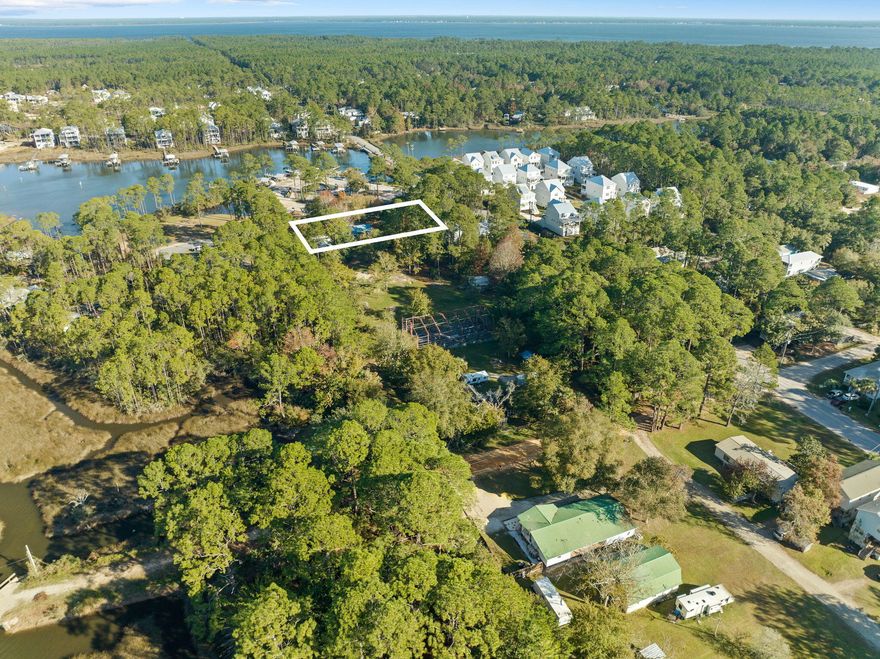 Seize this incredible opportunity to own a .52-acre parcel with breathtaking bayou views, ideally situated directly across from Cessna Landing Park. This property offers endless potential--whether you're looking to build your dream home or invest in a prime location with no HOA restrictions. In addition to this parcel, there 62 W Wilson Street is also available for purchase, providing expanded design possibilities and investment potential. This property does have a three-bedroom, two-bathroom home that could be ideal for expansion or a custom rebuild. The 1,152 sq. ft. residence includes a screened-in porch and a 24 x 12 workshop, perfect for storage or projects. Boating and outdoor enthusiasts will appreciate the unparalleled access to Hogtown Bayou, Choctawhatchee Bay, and beyond. Cessna Landing Park, just steps away, serves as a popular launch point for exploring Sandestin, Crab Island, Destin, Panama City Beach, and the Gulf of America via the Intracoastal Waterway. For those who prefer land-based adventures, head just a few miles south on County Highway 393 to reach Gulf Place, Shunk Gulley Oyster Bar, and the stunning white sand beaches of 30A.This is more than just a home,it's a lifestyle waiting to be embraced. Property being sold AS IS. Information contained within this listing such as square footage, is deemed to be accurate but is not guaranteed. Buyer to verify. Additional property available MLS #: 970728.