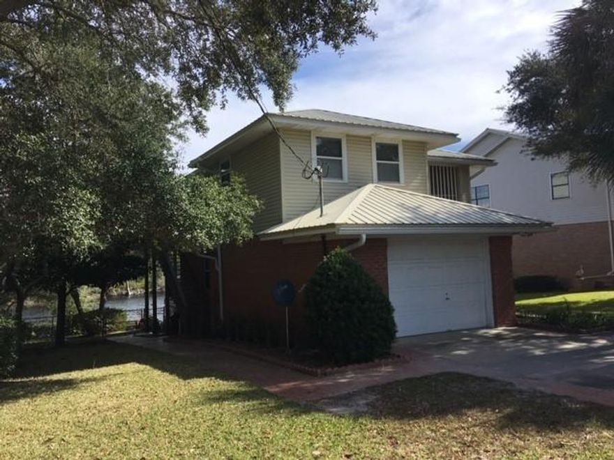 The Blue Mountain Beach life awaits you on one of the country's few coastal dune lakes. Fish off your own dock; paddleboard, kayak, or canoe in 22 acre Big Redfish Lake; sip coffee as you watch the sunrise from your lakefront gazebo; and walk to the beach from this home, which is south of 30A!! The home is on 1/5 acre and has a metal roof, fenced backyard, 1784 sq ft, a huge Florida Room (27x11) with lake views, large covered back porch, 3 bedrooms and 2 full baths, plus another full bath in the garage for washing off after a day at the beach or for bathing the dogs. The dock was damaged in the hurricane and needs repairs, and the home has not been updated. This is a great opportunity to have waterfront living on a coastal dune lake, just 2/10 mile from the beach!
