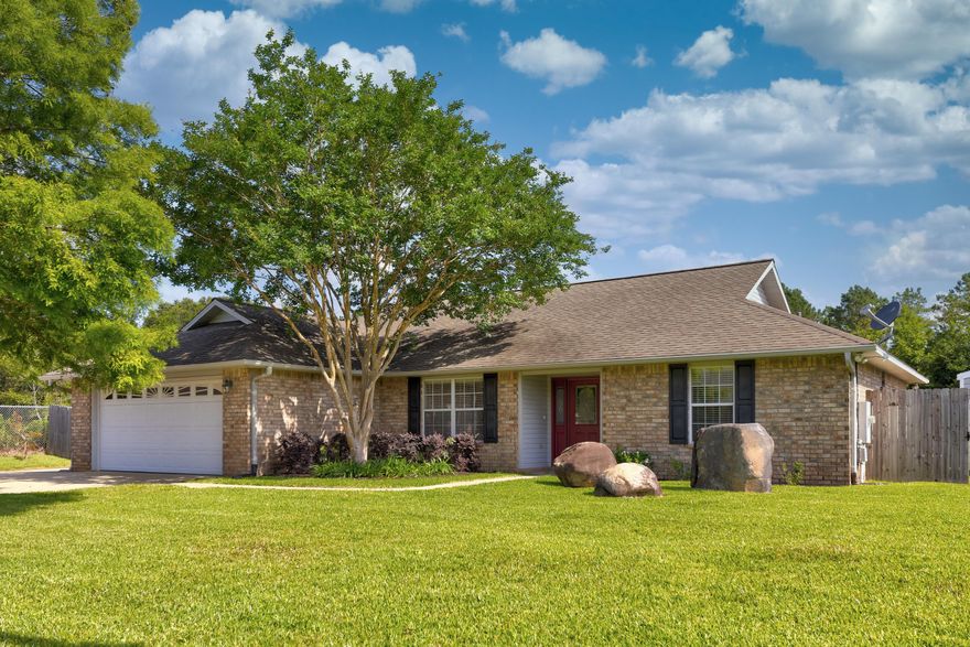 Welcome home to 3350 Joanna Dr. in Pace, FL! From the minute you pull into the expanded driveway, you can tell that this well-maintained three-bedroom, two-bathroom home is loaded with features and extras. The living room is full of natural light, has tall ceilings and a wood-burning fireplace. The kitchen includes newer stainless steel appliances, lovely granite countertops, white cabinetry, a tile backsplash, a pantry, and a breakfast nook. The well-thought-out split floor plan makes the primary bedroom a private oasis with its own access door to the back patio, crown molding, ensuite with double vanities, stand-up shower (with a NEW pivot door), a soaker tub, dedicated linen closet, PLUS a spacious clothes closet. But wait! The tour doesn't end there! Out in the backyard, you will find