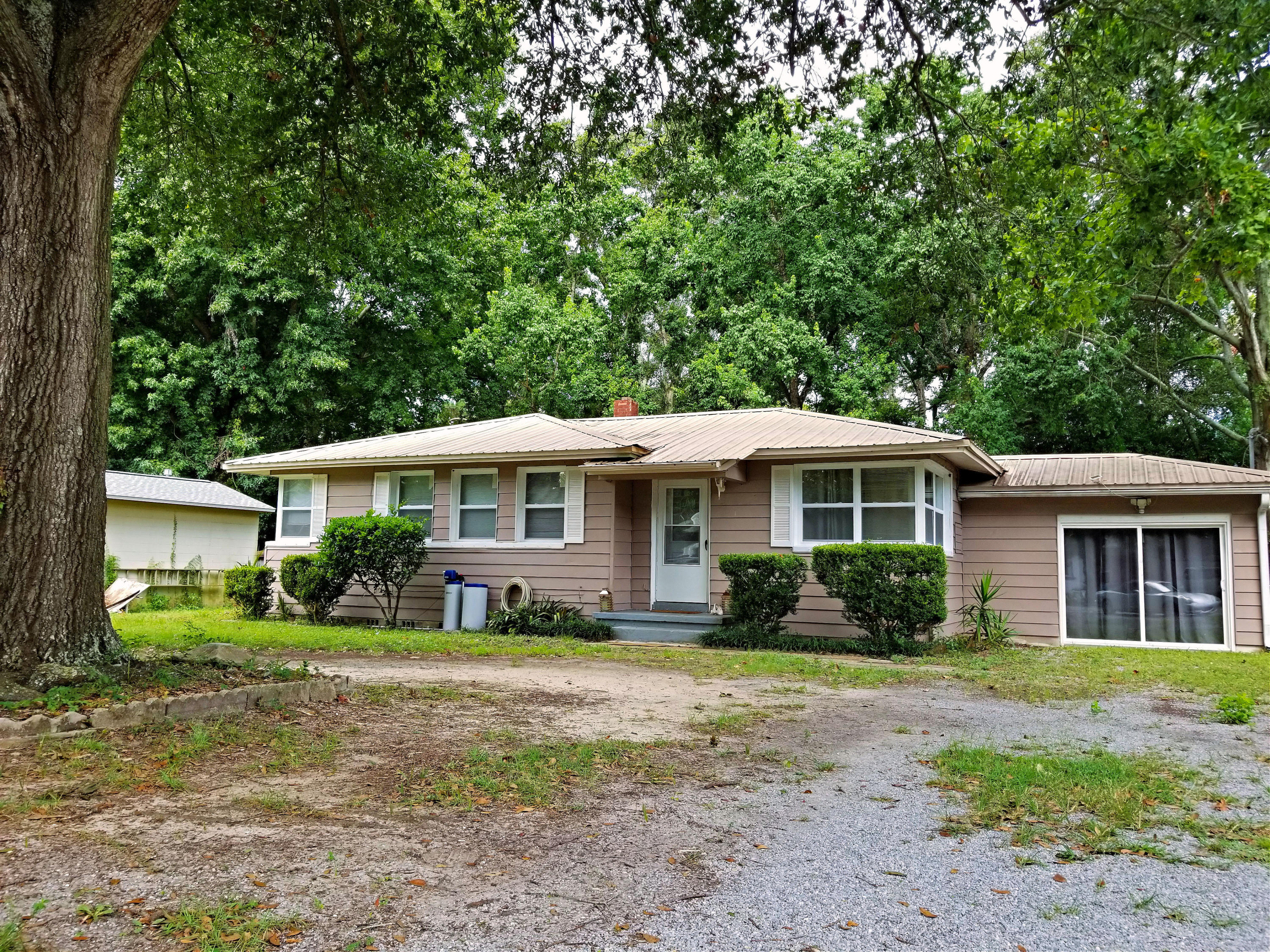 Great older home in the perfect location on a large lot in Garniers Beach. Close to waterfront park, grocery store, shopping, & banking. This 4 bedroom home has brand new windows w/ Hurricane fabric covers, gas hot water heater, gas stove, beautiful tile flooring, barn style doors, and so much more! Entertain on the large back deck overlooking the fenced backyard. This one is a must see!