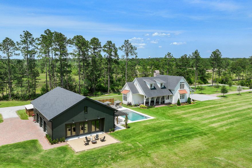 A Truly Rare and Unmatched Opportunity in Freeport, FL. For those dreaming of being close to the beach--yet far from the crowds--this extraordinary 5-acre estate offers the perfect blend of privacy, space, and future potential. Nestled just 5 miles east of Hwy 331 on scenic Hwy 20, this beautifully crafted homestead is a one-of-a-kind retreat in the heart of fast-growing Freeport. Subdivided into four platted 2.5-acre lots, this estate also features 2 additional lots for sale if you're looking to expand for your kids to have houses next door, build additional homes to sell on individual parcels, or simply enjoy the privacy and acreage all to yourself. With approximately 8 acres cleared, a picturesque pond, and a tree-lined entrance, this land is as usable as it.. is stunning. The 3,382 sq ft custom-built main residence is a showpiece, featuring 4 bedrooms, 4.5 bathrooms, wide-plank white oak floors, shiplap walls, Sierra Pacific windows/doors with white oak interiors, and two oversized porches overlooking serene pasture views. The open-concept kitchen, living, and dining areas include a breakfast nook and a spacious butler's pantrydesigned for everyday comfort and elegant entertaining. Step outside to find a 16'x32' resort-style pool with shellstone decking, raised garden beds, a fire pit, and ample room for play, relaxation, or gatherings. This is the kind of place where memories are made. A 2,581 sq ft fully climate-controlled 40'x60' detached garage/workshop offers serious bonus space with a 12'x24' guest suite and full bath, ninja-coated floors, retractable batting cage, workout zone, storage mezzanine, and Sonos sound systemideal for hobbies, hosting, or multi-generational living. Plus, a separate 36'x48' metal pole barn provides plenty of storage for equipment, boats, or recreational gear. Surrounded by upscale equestrian properties and family homesteads, this property supports a lifestyle of gardening, livestock, recreation, or just peace and quietall with no HOA and only minutes to Freeport amenities and the white-sand beaches of South Walton. Whether you're looking for a legacy property, a private family compound, or a unique investment with room to growthis is the one that rarely comes along.
