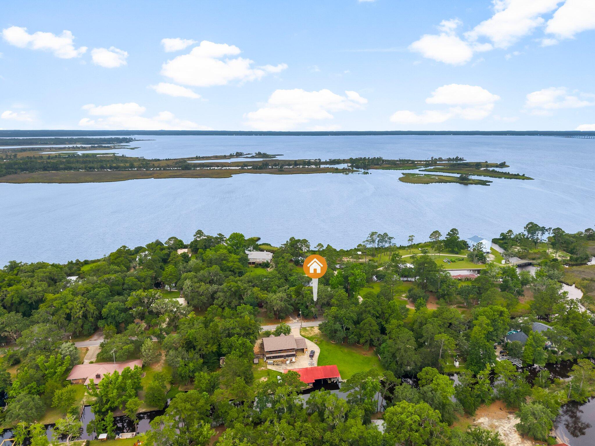 Breathtaking WATERFRONT PROPERTY! This one of a kind bay front property has not been on the market for over 50 years. It has been meticulously cared for and updated over that time. The home sits on a canal front .34 acre lot and includes a second lot on Jolly Bay, measuring .33 acres, bringing the total lot area to approximately .67 acres. Walking through the front door you find a spacious open-concept dining area and living room. Central to this space is a beautiful custom built mantel and wood burning fireplace. Looking out back you are greeted with views of the bay over your private in-ground pool and screened in porch, perfect for sitting and enjoying the summer days. There are two bedrooms on the east side of the home that share a hallway bathroom. The master bedroom is separated on the west side of the home and provides privacy, a view of the bay and an ensuite bathroom with walk in shower. It also features a unique walk in closet area with its own custom built vanity, sink and mirror.
The kitchen is located at the front of the house and provides ample counter and cabinet space for all your family and entertaining needs. Just off the kitchen is a nicely done closed in garage/sunroom that provides a generous flex space for many possible uses. The covered carport gives you a weather free entry to the house and also features a workshop with ample room for storage or any hobby that you may need indoor space to accomplish.
The best part of it all, you're on the water and have your own personal access to Jolly Bay, Choctawhatchee Bay, The Gulf and anything beyond! The beaches of 30A are only a 15 minute drive and jump on your boat for a short ride to great dining, to include The Bay, North Beach/Farm and Fire, Nick's Seafood and more! Come take a look at this legacy property and imagine yourself living the "Old Florida" lifestyle of your dreams!