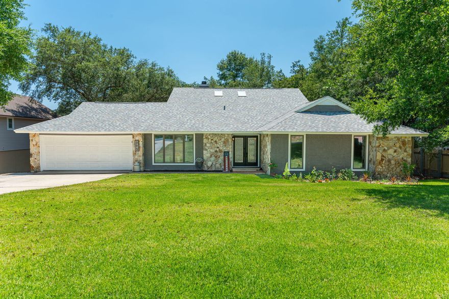 Welcome to this fully updated lakefront home located on over 1/3 of an acre in Bluewater Bay with no HOA! This 3 bedroom, 3 full bath home has soaring ceilings and tons of natural light with epic views of the lake behind the property. It is move in ready and boasts updates like: New Roof 2023, New Water Heater 2023, HVAC 2019, New Backyard Fence 2024, Remodeled Kitchen in 2019 with Farm Style sink, Custom built in Pantry, & New Back Splash in 2024.The Living Room makes a great impression with high ceilings, a stone fireplace as a central focal point and adjacent built-in shelving is a great way to show off decor. Sky lights and massive glass doors give the room a light and airy atmosphere while maximizing the views through the finished Florida room to the lake. The views continue in the