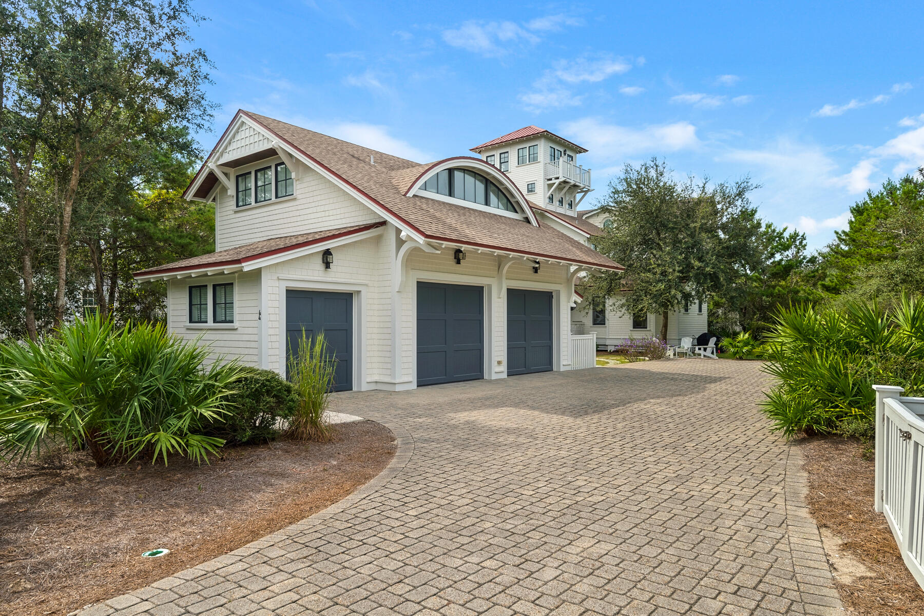 Stunning home in Watersound Bridges with spacious lot and carriage house. Recently updated interior complete with gourmet kitchen and fabulous master suite. The lower level includes 3 bedrooms, 2 baths, kitchenette and spacious living room with fireplace. The second floor has second living room with fireplace adjacent to kitchen and dining area in addition to the laundry and half bath. The 3rd floor is dedicated to the Master Suite with lovely updated bath, spacious walk in closet, additional laundry facility and a spiral staircase leading to the tower room. The tower room provides views of both the Gulf and Camp Creek Lake, perfect for a private office area or sitting area. This home has an abundance of covered porches on multiple sides to enjoy outdoor living. There's also a centrally