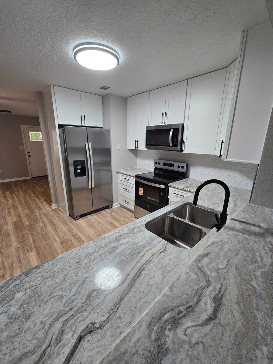 SELLER OFFERING $5K CLOSING FOR BUYER AT FULL PRICE OFFER!! Few details being finalized. Welcome to 7653 East Bay Blvd.. Navarre. What a rare find on 1.2 Acres. 3/2 1600 feet living space.Roof 2016, HVAC 2023-2025, New Hot Water Heater, New Septic Tank being installed. Updated home on 1.2 acres. Rare find. New kitchen, Stainless Appliances, Granite Counter-top. New Flooring throughout home. Laminate in main areas, luxury vinyl in baths and Carpet in Bedrooms. New Paint inside and Out. Update baths with New Vanity, Light, Mirrors, etc., New fans and lights,  textured ceilings, New interior doors.