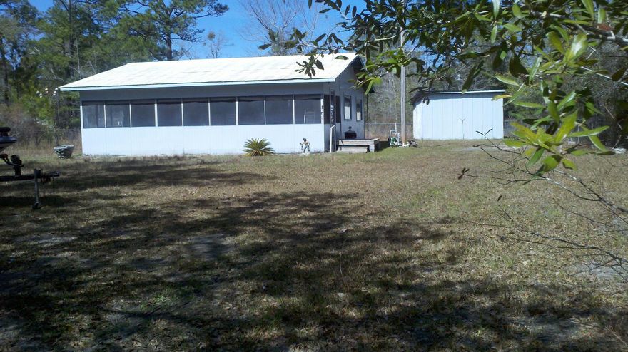 PRICED TO SELL! BLACK CREEK LODGE FISHCAMP! Popular Black Creek with lucky fishing waters of Black Creek, Choctawhatchee River, Mitchell River and more! Great weekend camp for the sports enthusiasts! Screen porch to relax & talk about the fishin' stories. Cabin style floorplan with open kitchen, living & dining area. Older storage building. Chain-link fenced yard. Enjoy the fishing or the Beach - just 10-15 minutes away. Great spot for fun and you won't break the Bank!