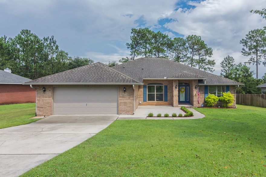 Sunning 4 bedroom, 3 bath home with additional office! Walking to the front door you will notice the versatile extended porch. As you enter fall in love with the wood laminate flooring throughout the home. No carpet here! There is a formal dining room and office at the entry way. Floor to ceiling windows and 9 foot ceilings allow for this space to be light and relaxing. The living room features double ceiling fans, soaring ceilings, fireplace, decorative ledges, and neutral colors. Kitchen boasts breakfast bar, pantry, eat in area, stainless steel appliances including side by side fridge, smooth top oven/stove, built in microwave, dishwasher, and even a pull down handle faucet.  The master is a dream with trey ceiling, ceiling fan, wood flooring, garden tub, walk in shower, double vanities