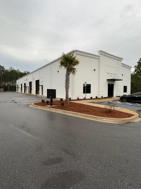 End Cap with storefront glass and doors, fully heated and cooled space with 2 offices, 2 bathrooms and large warehouse space with electric roll up door.