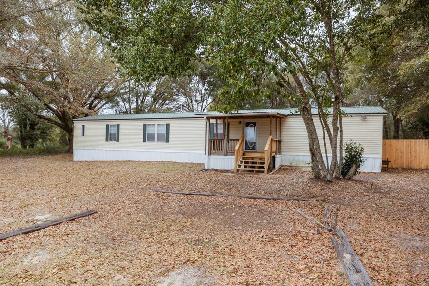 Great opportunity to live in the country with easy access to Highway 90, bases, beaches, and shopping.  3/2 country home features wooded privacy and has been recently renovated.  Half acre lot in Holt with plenty of parking, no HOA, minimal traffic, and is partially fenced.  Spacious living and kitchen areas.  New laminate flooring, new paint and renovated bathrooms.  Covered front deck is perfect for rocking chairs and a swing.  The master bath boasts a garden tub, separate shower and walk in closet.    Two additional bedrooms with a full bathroom and a large laundry room.  Partially fenced backyard is perfect for gardening, outdoor activities, entertaining and lounging.  Relax under the stars and enjoy country living.  No smoking or vaping in the home.  Pets allowed with approval.