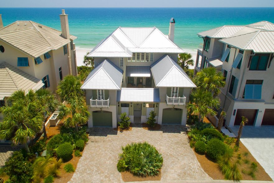 Welcome to this impeccably crafted concrete villa, where timeless elegance meets a premier beachfront location. From the moment you step through the private courtyard entrance, you'll be captivated by the exquisite finishes, thoughtful design, and striking attention to detail that define this stunning beach manor. Designed with entertaining in mind, this spacious retreat features 5 bedrooms, 5 full baths, and 2 half baths--perfect for hosting gatherings or relaxing with loved ones. Take in sweeping Gulf views from two expansive beachfront balconies, savor meals in the open-concept living and dining areas, or unwind in the generous media room complete with a full wet bar that seamlessly connects to the outdoor patio. An elevator services all levels of the home, offering both comfort and convenience throughout. Whether you're enjoying ocean breezes, toasting with friends, or creating unforgettable family memories, this luxurious villa delivers the ultimate coastal lifestyle.