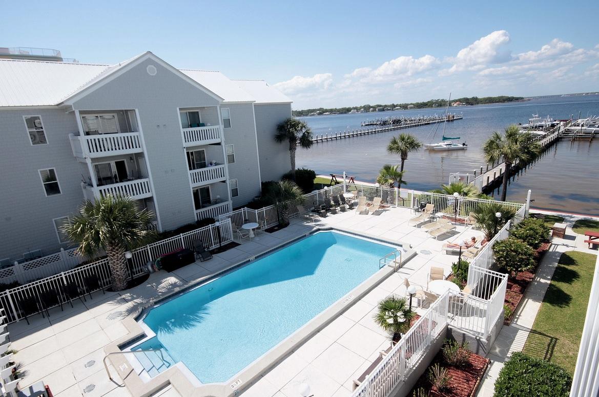 Conveniently located on Okaloosa Island in between Destin and Fort Walton Beach. You can go from the white beaches of The Gulf of Mexico at John Beasley State Park to the Choctawhatchee Bay just by crossing the street. Enjoy fishing from the complex private dock or swimming in the bay front pool. The Hermitage by the Bay is a quiet waterfront community of 42 units. Condominiums were updated in 2004 with new metal roof, new siding, new pool deck, landscaping and two grill/picnic areas. This would be perfect for a boater as you are minutes from Crab Island and Destin Harbor.