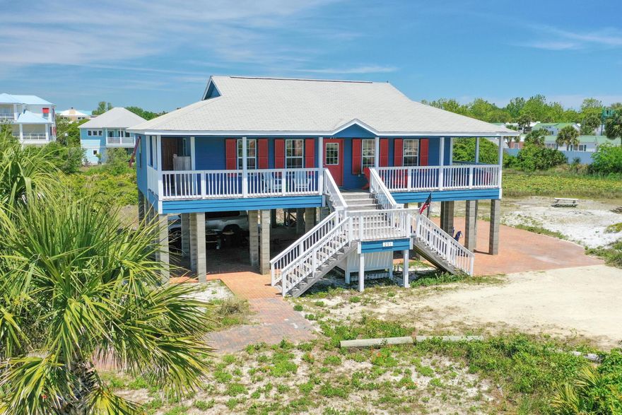 Enjoy gulf breezes, water views, and coastal living in this adorable beachside bungalow! Just a short distance from the private deeded beach access, this home is perfect for a weekend getaway, family vacation home or investment property.  The wide, wrap-around front porch welcomes you inside where you will feel as if you've been transported back to a simpler time of easy, carefree, beach living. This home offers 3 spacious bedrooms, 2 baths, an open-concept living/kitchen/dining area and extra storage. Upgrades include laminate flooring throughout and new in 2021 a/c compressor, washer and dryer and exterior paint. Outside, you will love the charm of the rustic outdoor shower and the expansive covered  and paved entertaining area, perfect for gathering to enjoy dining, games or just