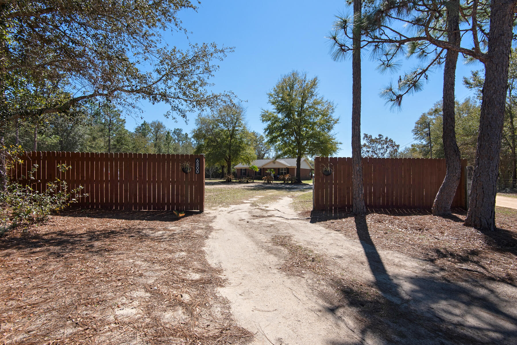 Charming single-story brick home nestled on 2.2 acres of fully fenced, level land--ideal for those seeking a peaceful, rural retreat and/or sustainable living with the possibility of a farm-style life. This property offers the perfect balance of serenity and convenience, located just a short drive from Crestview shopping and I-10. The home features a well-maintained layout with ample space for relaxation and enjoyment. A standout addition is the 24x30 separate building with both roll-up and entry door access, perfect for storage, hobbies, or a workshop. The roof boasts durable 30-year architectural shingles for added peace of mind. Don't miss out on this fantastic opportunity to embrace country living with easy access to urban amenities!