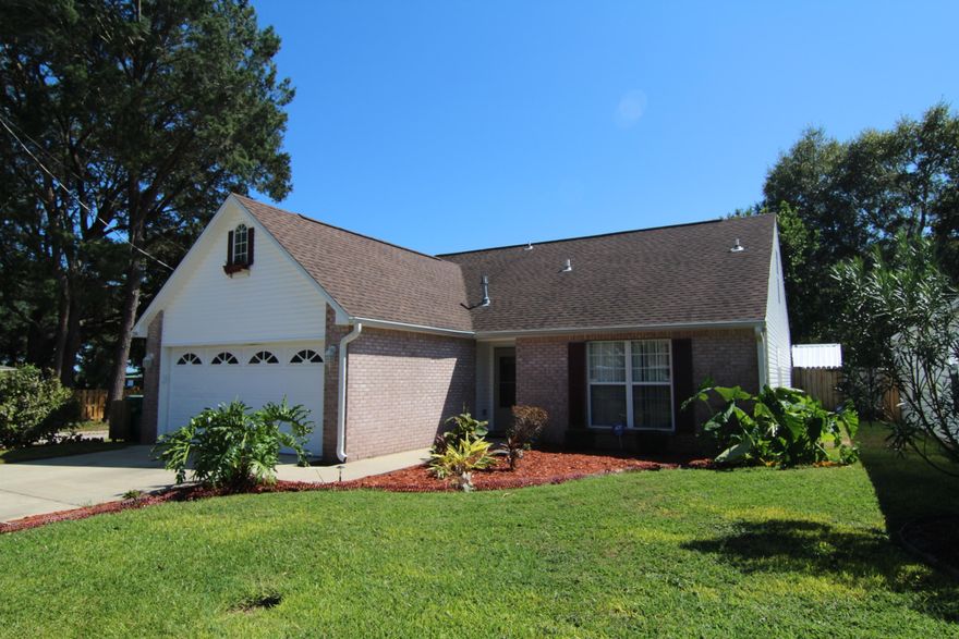 A CHOICE LOCATION! Wonderful home situated on a quiet street across from the water. Fantastic curb appeal and the low maintenance exterior will put you on easy street. Spacious living area with vaulted ceiling, corner gas fireplace, Italian marble tile flooring and a new sliding glass door that leads out to the backyard. Dining area opens into the living area with crown molding and wainscoting great for entertaining. Light and bright kitchen with gas stove, pantry and tile flooring. Breakfast area overlooks the backyard. Master bedroom has a walk-in closet. Master bath has double vanities, separate shower and garden tub with glass block accent above. Additional bedroom downstairs could easily be used as a den/office. Half bath conveniently located off the living area.