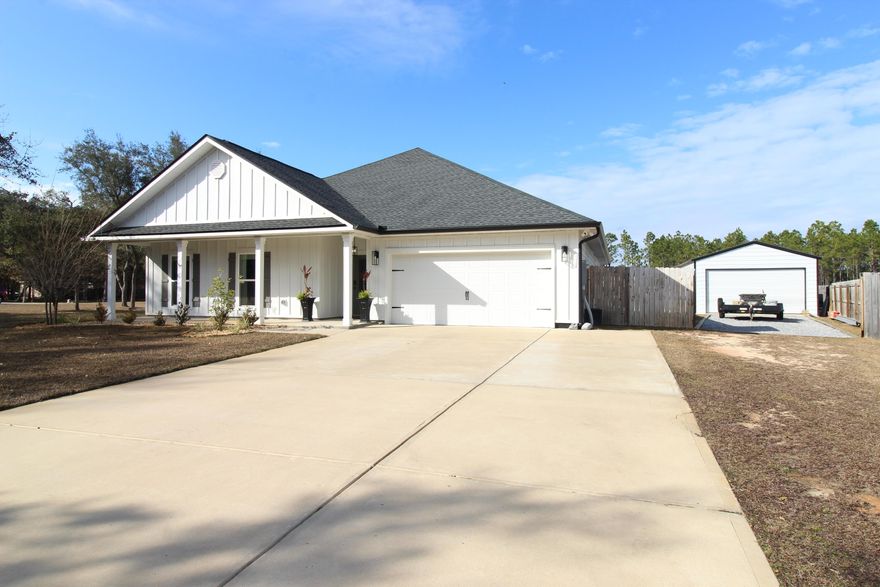 Discover this fantastic home situated on a half-acre lot at the end of a quiet cul-de-sac within Indian Bay, One of Choctaw Beach best-kept secrets, Indian Bay offers a private community dock for easy accesses to the Choctawhatchee Bay. Only a few years new, this one-story home at the end of the cul-de-sac Invites you first with a wide, covered front porch offering a warm Southern welcome, leading you into a beautifully laid out split-bedroom floor plan designed for both comfort and sophisticated entertaining. At the heart of the residence, the expansive open-concept living area with custom built bump out wall featuring an electric fireplace surrounded by ship lap flows seamlessly into a gourmet kitchen adorned with elegant quartz countertops, shaker-style cabinetry, and a center island  island illuminated by custom lighting and top of the line appliances. This central hub is ideal for hosting large gatherings or enjoying quiet family evenings alike. One wing of the home provides a private retreat for guests or family with three spacious bedrooms and a full bath featuring a double-sink vanity, while the primary suite serves as a secluded sanctuary on the opposite side. This luxurious primary retreat boasts a massive walk-in closet and a spa-like en-suite bathroom complete with a tiled shower, garden tub, and a double-sink vanity. The excellence of this property extends outdoors to a private oasis. Step outside to find a stunning brand new gunite pool enhanced by a custom water feature, all set within a manicured privacy fenced back yard. The outdoor living space is further elevated by a covered patio and an extended concrete pad that hosts a custom-built pergola with a beautiful tongue-and-groove-stained ceiling. This space is perfectly equipped for movie nights under the stars with its own outdoor projector screen. For those with hobbies or storage needs, the property includes a massive 20ft x 30ft warehouse/ workshop finished with electricity 100amp service including 120/240V outlets. Sprinkler System and Lawn pump for convenient lawn maintenance. Complete with a cozy fire pit for cool evenings and a double-gated entry to an expanded driveway, this home offers an unparalleled lifestyle of luxury and utility.