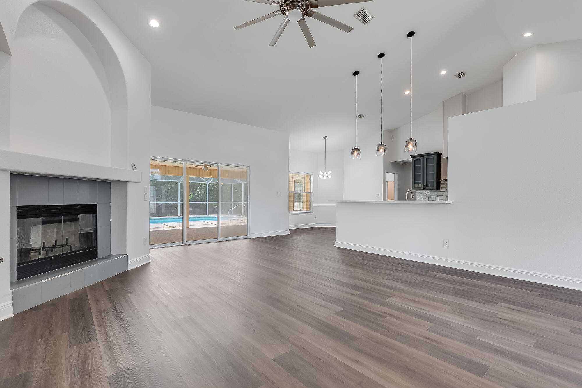 This 4 bed, 3 bath home with sepratate office sits on over half an acre with a fully fenced yard and a beautiful screened pool. Inside, enjoy soaring ceilings, a bright open floorplan, and a chef's kitchen with quartz countertops, custom island, and pantry. The spacious layout includes a second master suite with en suite bath and private access to the pool--perfect for guests or multigenerational living. The main suite offers a walk-in closet, a spa-like separate bath and shower, and private lanai access. Tucked on a quiet cul-de-sac with a low HOA and no stairs, this home offers style, space, and comfort all on one level. Roof, HVAC and water heater have all been replaced in the past 3 years!
