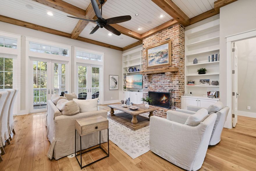 Just a short walk to the beach! This stunning custom-built home in the highly desirable Non Short Term Rental, Sea Dunes subdivision offers privacy, style, and exceptional coastal living on one of the neighborhood's largest cul-de-sac lots the yard is a gardeners dream with mature oaks and abundant Camelias and Azaleas. The private backyard backs up the preserve. Step inside the front door to a grand foyer with a domed ceiling and wood inlay compass rose floor, leading to a stately study with built-ins and beamed ceiling. The open-concept main living with it's 14' beamed ceilings, custom cabinetry, a sound system, and a masonry fireplace is a stunning area perfect for entertaining. The luxurious primary suite features a beamed ceiling, large walk-in closet, and a marble-adorned spa bathroom with double vanities, walk-in shower, and a beautiful freestanding soaking tub. The first floor also has a guest bedroom with full bath, powder room, laundry room, and a 2-car plus golf cart garage.The second floor is comprised of  the private guest suite with  its own living area with a built-in king-size Murphy kitchenette, bedroom, and full bathWonderful additional guest accomodations.Enjoy the huge front porch or unwind on the screened back porch. Move-in ready and perfectly positioned for the beach lifestylethis is coastal living at its best.