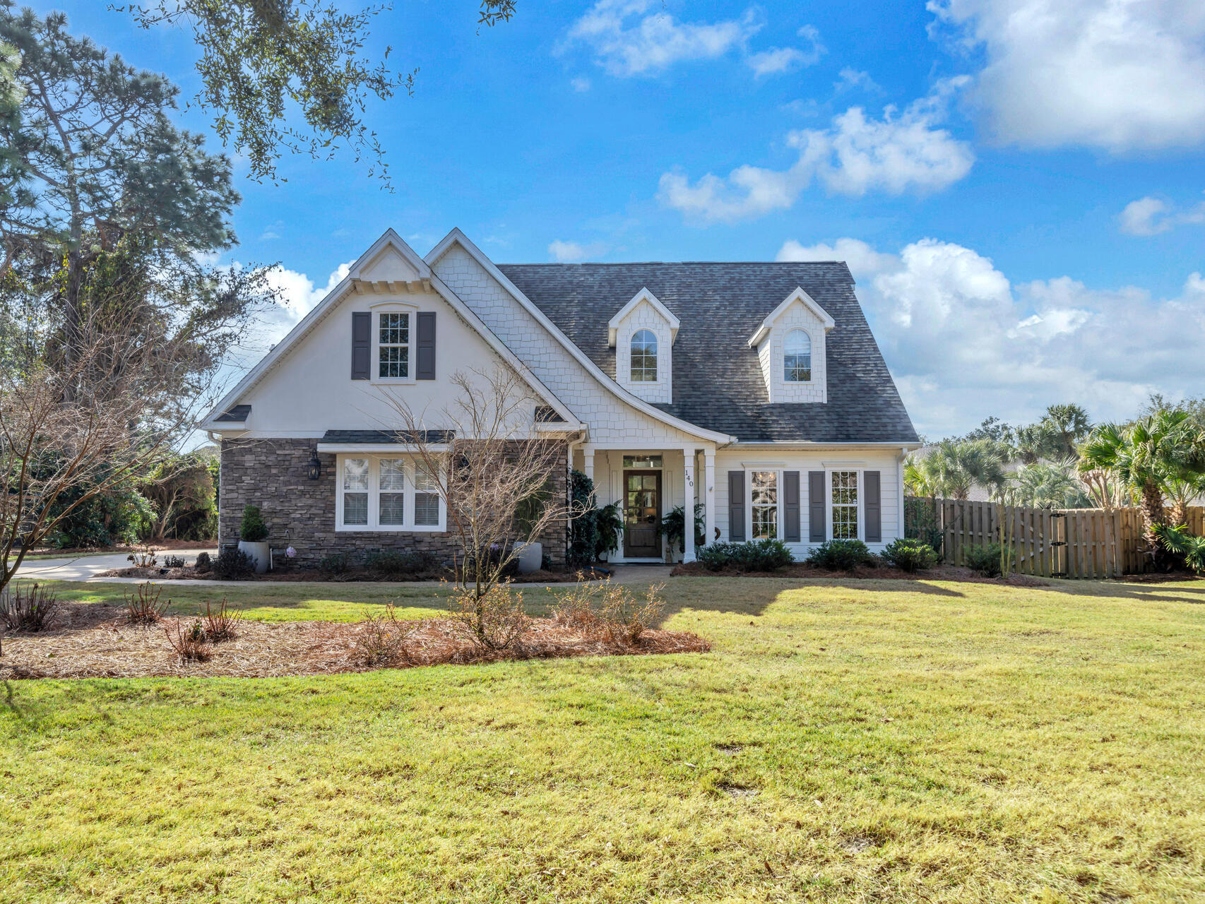 Welcome home! This gorgeous, recently renovated home is a must see! Situated on one of the largest interior lots in the highly desirable gated waterfront community of Botany Bayou. With nearly every surface updated, this home perfectly blends modern elegance with coastal charm, ideal for those seeking a primary residence or vacation retreat. Offering a spacious and thoughtfully designed floor plan featuring four bedrooms, including a primary suite on the main level, a bonus room that can serve as a fifth bedroom, two full baths and a powder room. The completely remodeled kitchen was taken down to the studs, reconfigured and now has custom cabinetry, custom built-in, quartz countertops, GE Cafe Series stainless appliances including a gas range. New hardwood floors were installed in primary suite as well as the second level bedrooms, gallery and bonus room. The luxurious master bath has been fully renovated with a soaking tub, new double vanity, flooring, walk-in shower and customized walk-in closet. The entire interior has been painted, including doors, new lighting and ceiling fans installed. Tankless water heater installed in 2021. There is an attached two-car garage plus a detached one-car garage, offering ample parking, storage or workshop. The large privacy fenced backyard provides a serene retreat with a covered porch perfect for relaxing and entertaining. There's plenty of room to add a pool! Botany Bayou residents enjoy a beautiful neighborhood, with lush landscaping, a community pool and pier. Conveniently located close to hospital, shopping, restaurants, attractions and it's just minutes to the beach. Please note that the washer and dryer, and the chandelier over the dining room table do not convey. Don't miss this incredible opportunity! Schedule your private tour today!