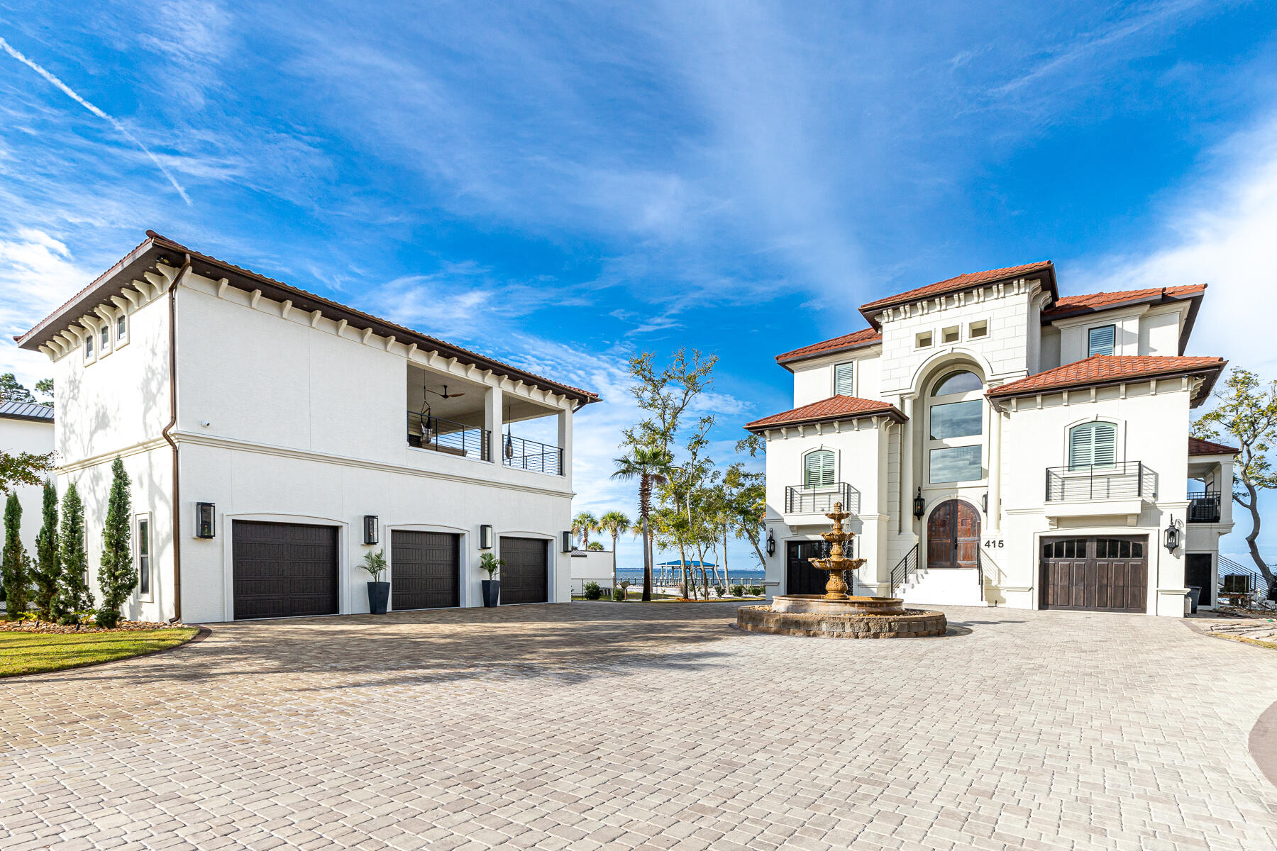 Just moments behind Sandestin Resort and Grand Boulevard's world-class entertainment, shopping, and dining, this gated, ICF built, private bayfront retreat claims 120 feet of bay frontage and year-round sunsets. From the winding paved driveway to the elegant fountain to the arched copper double doors, entering this almost 2 acre beautiful estate feels like an event. The minimalist landscaping and smart-house electronic controls ensure you can enjoy your time at home without worrying about all the fuss. The designer lighting, neutral finishes, and thoughtful furnishings, and unending views guarantee that every day is unforgettable.