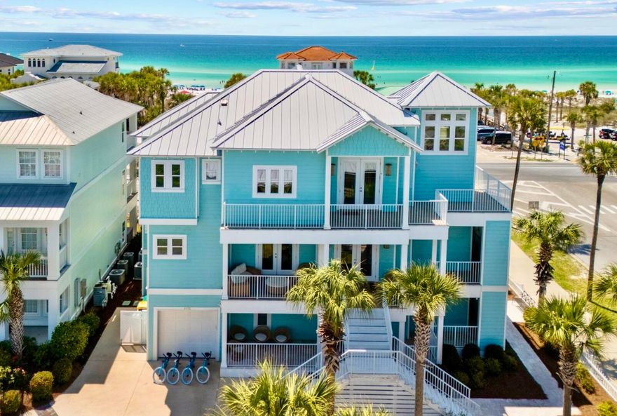 Turquoise by the Gulf at Crystal Beach, a professionally decorated and furnished luxury home features 15-foot ceilings in third floor main living area with Gulf views! Six bedrooms and seven and a half bathrooms, this home can accommodate up to 24 guests with almost 4900 Sqft. All bedrooms located on the southside and all but one are in site of the Gulf. Featuring wrap-around porches, patio and decks; enjoy the breezes even on rainy days with over 3900 Sqft of covered space. Enjoy the Sun by the large private heated pool and outdoor kitchen area with 36-inch grill, fridge, sink, 80-pound ice maker and smart TV. Complete with conditioned full bathroom and changing area. Outdoor shower located right by the gate with Hot and cold water! Inside the home you'll find top of the line everything. Travertine floors throughout with Marble in the third-floor primary bathroom. Pecky Cypress accents and whimsical d??cor throughout. Open gourmet kitchen, living and dining room is truly the masterpiece of the Home. With 15-foot ceilings and the sparkles of the Gulf Blue waters, it is the perfect spot to eat, drink and socialize. Stainless appliances include Bertozonni 48-inch gas range, Liebherr refrigerators with dual ice makers plus undercounter 65-pound ice maker, beverage fridge and two dishwashers. Two separate laundry areas with washer/dryer. Large islands with bar seating two dining tables. Two Rinnai tankless water heaters and each floor has separate air conditioner. Elevator services all three floors and has interior and exterior stairs for convenience.  
All bedrooms have custom furnishings and d??cor with all having balcony and seating area. Second floor has eat-in coffee bar area with beverage fridge and sink. Built-in bunk room and billiards room on first floor each with its own full bath. Second floor has large Primary suite with custom shower and seating area. Two adjacent bedrooms that share a bath have queen and twin bed and a full. Fourth bedroom with king bed and private bathroom and dual closets. Third floor Grand primary suite has prime Gulf views with private balcony. The entire private bathroom is covered in imported Calacatta Vagli Marble with seamless glass shower and separate soaking tub. 
Corner lot with Perfect location which backs up to Scenic 98 and only steps from the Beach. Easy, walkable access to the public beach area. Quaint community has pool and lighted sidewalks for a nice stroll. Restaurant across the street is a local's favorite with live music Thursdays, Fridays and Sundays. Come check out this unique Destin Luxury home! 


