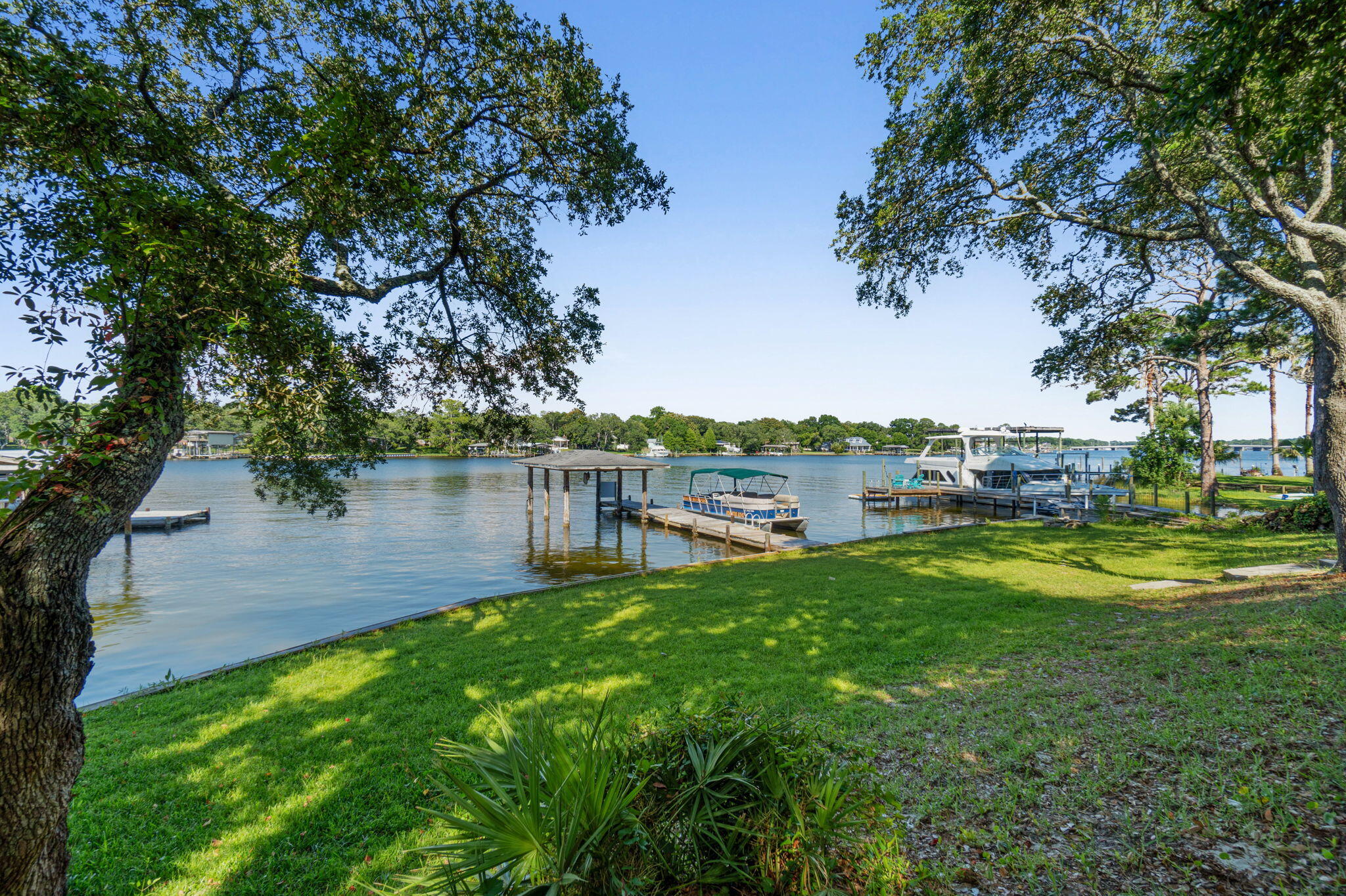 Stunning waterfront property in the Cinco Bayou area. 4 bed, 3 bath home sits on over 1/2 acre, and has a deep water dock. LVP Flooring throughout the home. Updated kitchen with quartz counter tops and tile backsplash, a large island with a breakfast bar and stainless appliances. The Florida Room walks out to the beautifully treed back yard, for plenty of shade while sitting on the deck enjoying the view. Solar panels were installed in 2022 and a new roof was installed in 2020. Currently being used as an Airbnb, but this would make a wonderful place to call home if you have always dreamed of living on the water. Centrally located to the Military bases, shopping and restaurants or a short boat ride to Destin & Crab Island.