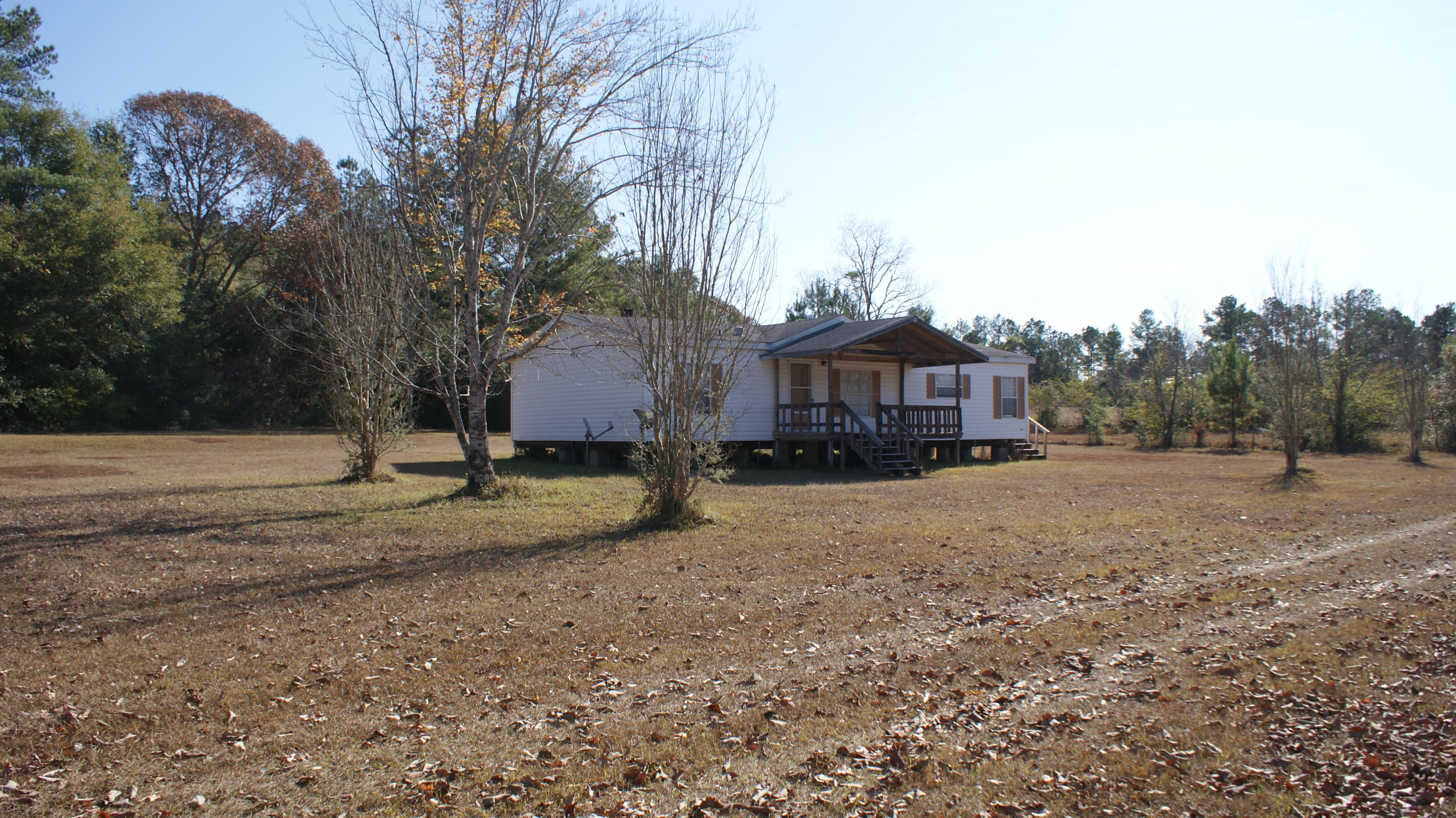 Check out this mobile home and beautiful property in Laurel Hill! With approximately 2.6 acres and just under 1300 sq ft. this may be just right for you. A new roof has recently been installed and looks great. Call today to set up your showing of this home before it's gone.