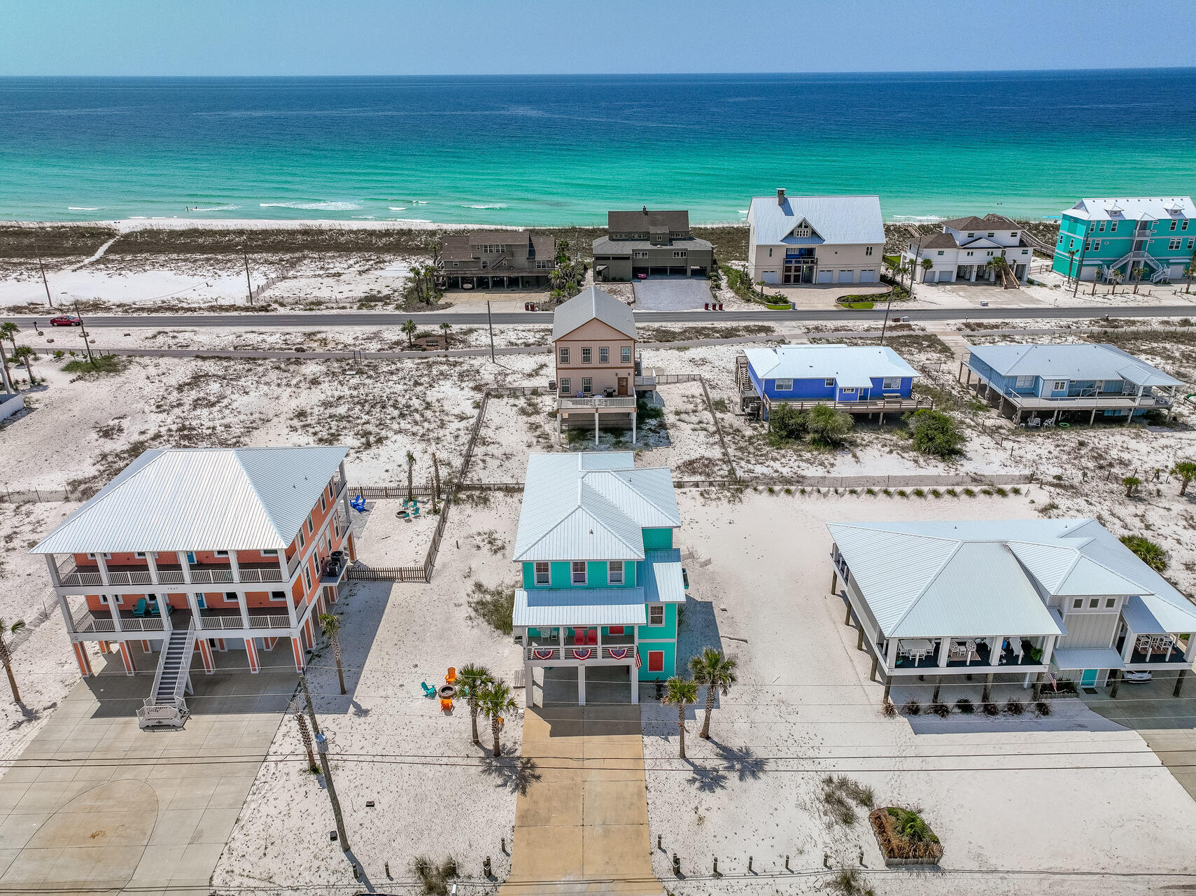 This stunning beach house boasts a prime location just steps away from the gulf and sound. With 4 bedrooms and 3 bathrooms, it offers ample space for relaxation and entertaining. The interior features an open floor plan with large windows that flood the space with natural light and provide breathtaking views of the water from the many balconies. The kitchen is equipped with top-of-the-line appliances and tons of counter space for preparing delicious meals. The outdoor area includes a spacious deck and patio, fire pit/tables/swings, perfect for enjoying the ocean breeze and hosting barbecues. Don't miss out on the opportunity to own this dream beach house.Take your flip flops off and enjoy! FYI NO HOA OR RENTAL RESTRICITIONS