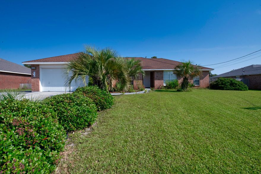 Navarre's newest all brick, beautifully landscaped 3 bed 2 bath home has officially hit the market! No HOA, but still capturing all of the identical qualities of gorgeous Navarre living. Alfred Boulevard is well kept, quiet, and centrally located to shopping, bases, Navarre beach, and a brief ride out to Pensacola. Park your boat worry free in the extended driveway, as you enter the home through the tropical landscaping! The home is clean and meticulously maintained, full of natural light in every room. A large great room is central to an open concept plan, while the chef's kitchen features a center island overlooking the eat in dining space. Fit a king bed with no issues in the master suite, large ensuite, with views of the manicured private backyard space. Do not miss out!