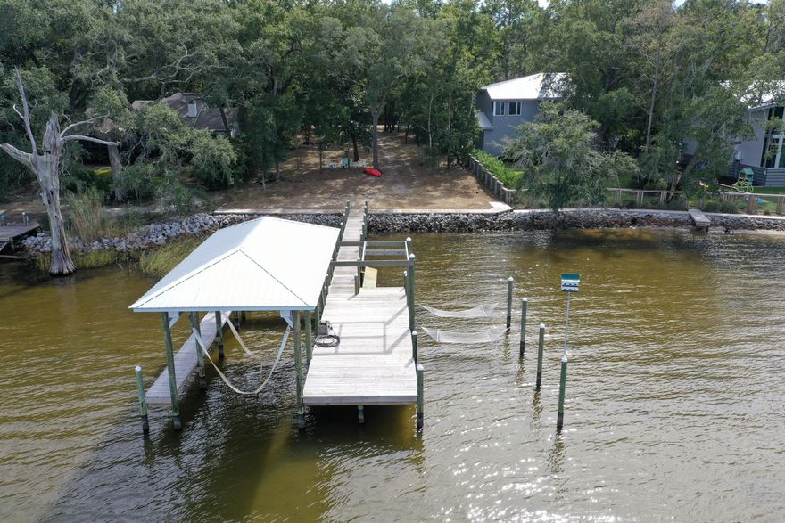 Tranquility on the Bay!  This 75' wide Bayfront lot in Pt. Washington is awaiting you.  The property is primarily in flood zone X and has a seawall, riprap, dock and recently upgraded boat lift to accommodate a 16,000 lb vessel!  There is a 3,700 sq ft set of stamped plans for a 4 bedroom home w a pool.  The Daugette subdivision also has no HOA!