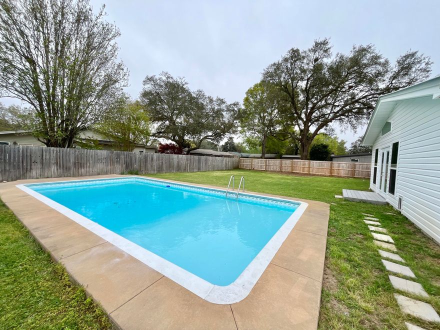 POOL home in Kenwood neighborhood. Seller has updated so much of this adorable home. Updated tile flooring throughout. Gorgeous kitchen with all  new cabinets, quartz countertops, appliances, recessed lighting, and  features a pantry with glass door for added storage Bathrooms updated w/toilets, vanity in hall bath & walk-in MBA shower. A 2018 remodel added a bonus room filled with windows. A combo full accessible bath and laundry room are located off the bonus room. The expansive backyard has a sparkling pool and 2 storage sheds. Endless other updates include replacing  the metal roof 2018, tankless gas water heater 2018,, new gas furnace, HVAC & ducts 2017, impact windows 2018, new interior & exterior doors, impact garage door, attic insulation, gutters, sprinkler system 2017, lawn pump well pipe/valve 2022, pool pump & new filter sand 2022, fence and gates, changed electric service to the house, new interior paint 2024. Solar panels added 2020. Seller will pay these off before closing. Power bills averaging $65/month. They really do reduce your energy costs! 