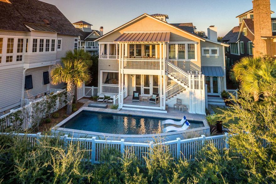 Lakefront living with pristine gulf views, located within the gated community of Watersound Beach, this is an exceptional legacy home. Upon entering the foyer, views of the lake provide the perfect welcome to this cedar shake Nantucket style treasure. The 1st floor hosts 4 bedrooms including the owner's suite, each with private porch access, an elevator, screen porch with summer kitchen, private lakeside pool with resort-style fire pit. At the top of the grand staircase is an open living area with enviable views of the lake and gulf.The showcase kitchen provides space for cooking and entertaining anchored by a venetian plaster gas fireplace. The 2nd floor boasts lakeside dining, media room and a 5th bedroom. Recent upgrades include new windows, doors, pool, paint roof and furniture!