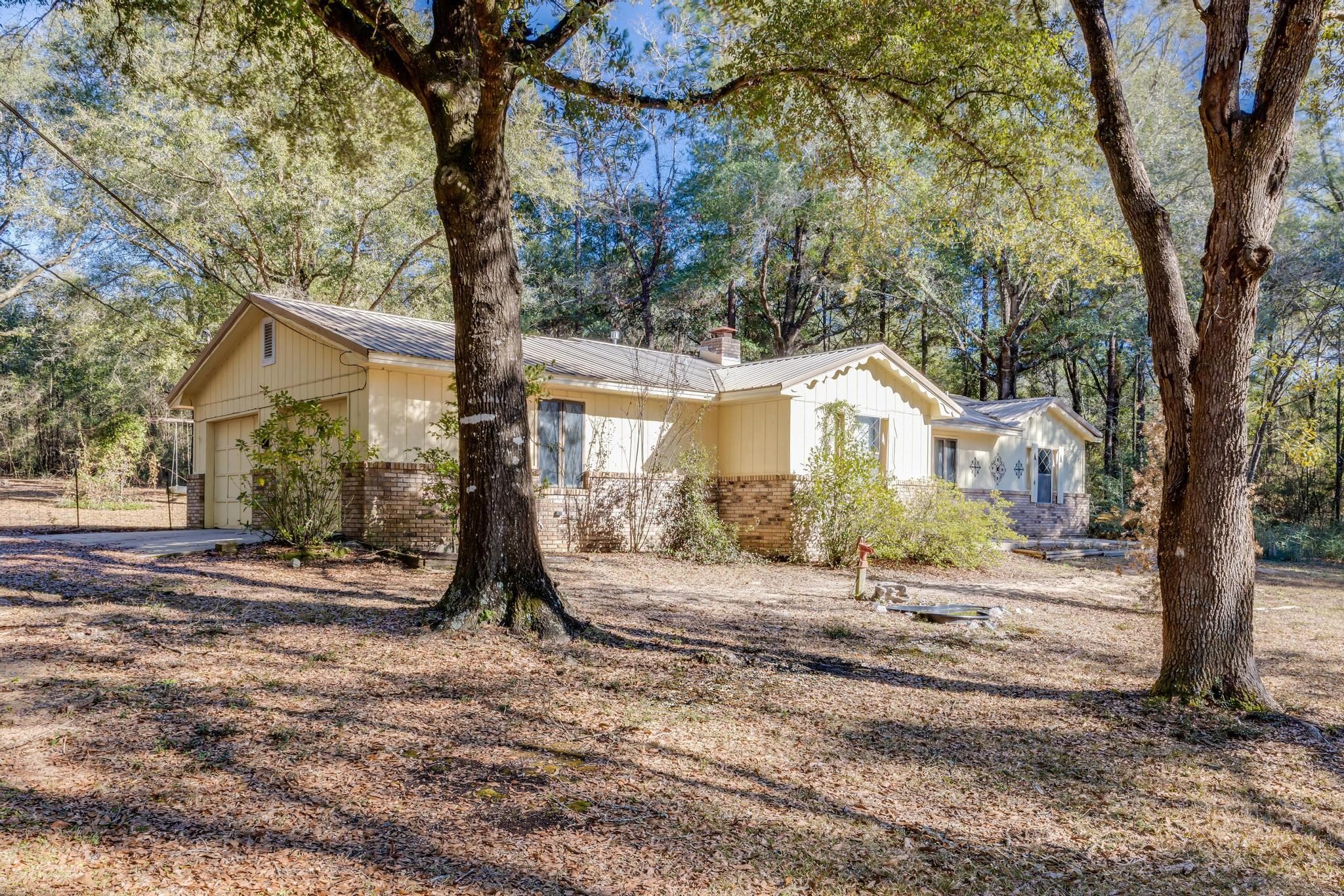 Come and check out this wonderful 3 bedroom 2 bathroom home located on the North side of Crestview! SELLER IS OFFERING $8,000 IN BUYER CREDIT FOR rate buy down, closing costs etc. The home sits on 2 acres of land with old growth trees and an amazing 24'X24' work shop! Upon walking into the kitchen with its open floor plan, you are greeted with all stainless appliances, including a brand new gas burning stove!! Beautiful wooden counter tops, along with wooden cabinetry for all your storage needs. There is tile all throughout the home with newer LVP in the bedrooms. Off the back of the home through the living area boasts a large Florida room with a window ac unit that could easily be updated to a newer split unit ac that is wall mounted. Large front and back yard, there is also an extra septic tank along with a well that is not in service, they will convey in AS IS condition. The home is currently in probate at this time, the offer will require approval.