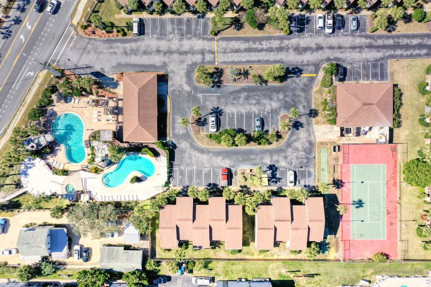 Walking distance from the beach!Enjoy three inground pools (including a seasonally heated pool in the center of development) , a private workout room, Tennis courts, shared common space with game room and a golf cart friendly neighborhood within a mile of a local convenient store!Are you looking for a home away from home, or possible rental?! This unit's landscaping upkeep is minimal, it has dedicated parking with a guest spot, and each story has a full bathroom. The unit features a balcony, owner's closet on the front patio, and the unit is able to be used for both short-term and long-term rental capabilities!  The unit has been updated, the HVAC is less than 5 years old, and there is a laundry area on the first floor.You are going to love this unit at Portside Condominiums!