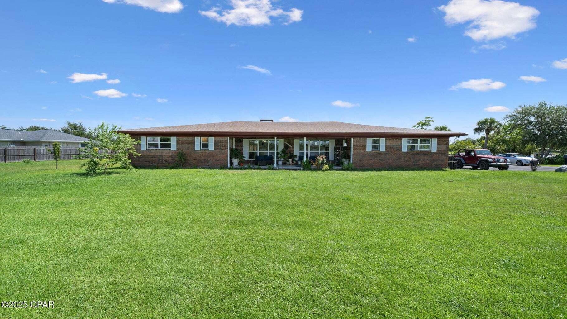 Exceptional Waterfront Retreat on Deerpoint Lake - 1.65 Acres Enjoy the perfect mix of privacy, modern upgrades, and water access in this beautifully renovated 4-bedroom, 2.5-bath ranch-style home with over 2,400 sq. ft. of living space and approximately 600 feet of shoreline wrapping around three sides of the property. A brand-new dock on the canal, private boat ramp, and expansive lot make it ideal for boating, fishing, and soaking in serene water views from nearly every angle, with all scenic views of the lake. Inside, you'll find fresh paint, new flooring, stylish light/ceiling fans, and custom wireless blinds throughout. The kitchen features new appliances, cabinetry, countertops, and fixtures, while the living area offers crown molding and a resurfaced fireplace. Bathrooms have resurfaced cabinets and updated fixtures, and the Florida room includes new flooring and paint.
Upgrades include a new well, new insulation, a new roof with hurricane clips and a transferable 50-year warranty, a new A/C system with ductwork, new windows and doors, a new water heater with filtration, and a 20' x 26' multipurpose building perfect for storage, hobbies, or a workshop complete with a full garage door.
This move-in-ready waterfront property offers unmatched features, comfort, and style perfect for year-round living or a weekend escape.