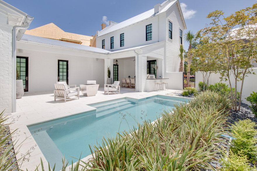This stunning, elegantly furnished home designed by Savoie Architects is situated on a beautiful spring-fed lake within the coveted bay-front enclave of Churchill Oaks. Offering 3 bedrooms, with the master on the main level, 3 and 1 half bathrooms, a 2-car garage, and  extraordinary features such as white oak floors, mahogany courtyard door and aluminum clad windows and doors. Outdoor amenities include a private courtyard pool, summer kitchen, fire pit, outdoor living room, and a veranda with lake views. The spacious first floor has an open living area centered around a gas ribbon fireplace, and a grand dining area with a full wet bar. The chef's kitchen includes beautiful quartz countertops, shaker style cabinets, Thermador appliances, and a walk-in pantry. Don't miss this one!