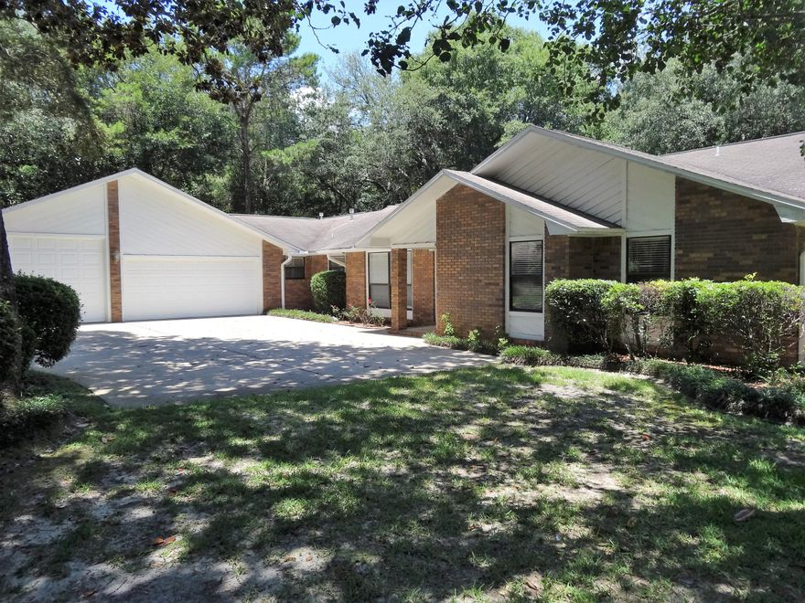 Located in a quiet neighborhood and nestled among canopies of live oaks is a custom builder's home with room to roam. The unique front elevation of the home draws you into SPACIOUS rooms and ABUNDANT closets and storage. The 3 bedroom, 3 bath floor plan is a split design making great in-law or guest quarters. The eat-in kitchen is open to the living room and dining room for entertaining and family gatherings. The grill chef in the house will love the back patio in the privacy fenced yard ~ all connected to a sunny Florida room. A 3-CAR GARAGE is more than a garage: the third bay is designed with a 10.5' ceiling for RV STORAGE. A WORKSHOP area, newer WIND RATED DOORS and ATTIC STORAGE complete the usefulness of the garage. Sept 2016 NEW ROOF!