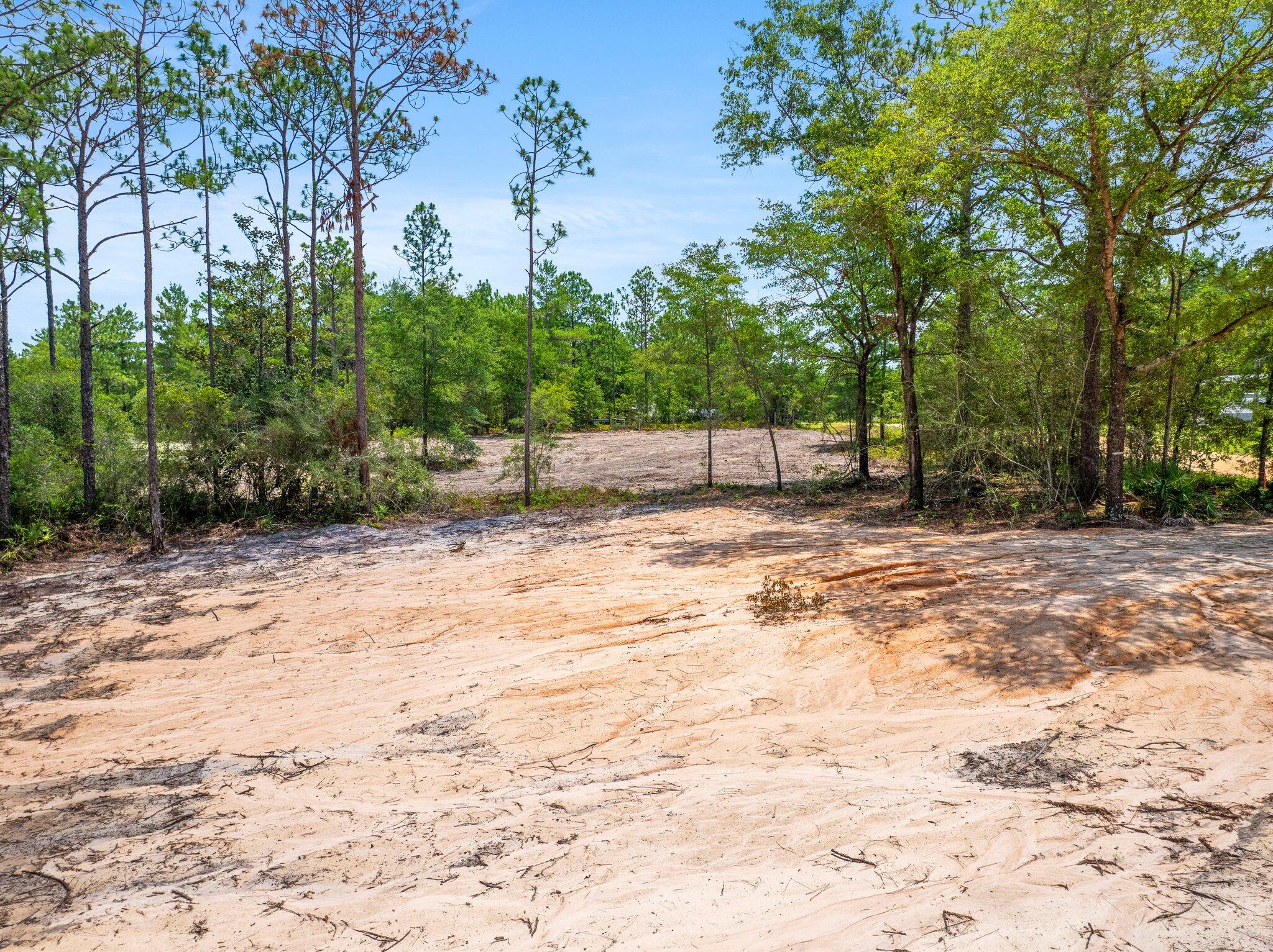 Great Opportunity: One Land Parcel ready to build! Discover one of the last remaining gems in this coveted area! We are exclusively listing Lot 30, located as the parcel on the right when facing the property from Laurel Lane (Lots 29/30 sold separately). This offering provides a unique opportunity to create your dream home, vacation retreat, or even place a mobile home. Buildable with a completed percolation test and fill dirt added. Mostly cleared with space for driveway. Enjoy the most beautiful beaches on the Emerald Coast, with convenient access to Highways 331 and 10. This location is ideal for both tranquility and accessibility. More... Prime Location and Features:
Convenient Access: Located with ease of travel to Crestview and Defuniak Springs via Highways/331 and/10.
Utilities Ready: Electric and water available at the street, with land prepared for septic on both lots.
Driveway: driveway has already been cut in.
Septic and Survey: Septic tests are completed, and the survey confirms there are no protected wetlands on the property.
Additional Highlights:
Scenic Surroundings: Beautiful trees, natural environment.
Privacy and Space: The land maintains privacy with surrounding trees.
Investment in Preparation: Over $10K in clearing and grading work has been completed, facilitating easier construction.
Potential for Expansion: Ideal for a guest house, a separate home, or mobile homes, maximizing the use of both lots.
Buyer to verify all information. Don't miss out on this exceptional opportunity to own a rare piece of land in a serene and accessible location. This property offers incredible value with significant preparation already completed. Start planning your dream home, vacation getaway, or mobile home setup today!