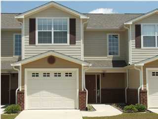 The well developed town home community consists of a nature preservation area with nature trails,a gazebo,and an overlook pavillion. Cool down after a long day at work by the community pool with deck and changing rooms. This location south of I-10 makes for a convenient drive to area beaches and military bases. This is a two story traditional design with brick and Hardy plank exterior. The floor plan has the living and kitchen downstairs and bed rooms up stairs. The garage makes a great way to keep you dry in the rain. Inside the tile floors large molding and whirlpool appliances will be in place for years of service.