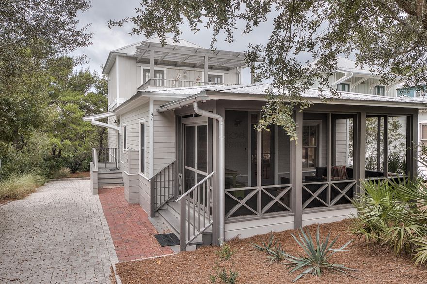 Charming beach cottage located in Magnolia Cottages By The Sea. The home is two stories featuring 2 bedrooms and 2 baths on the main and a private Master Suite with balcony on the 2nd level. The Master on the first floor includes a King bed and a private bath. The bunk room with 4 beds is across the hall from a hall bath. Just two lots south of the community pool and close proximity to the deeded beach access. Wood floors, stainless steel appliances, granite counters, new exterior paint, new extended pavered driveway is large enough for three cars, large screened porch, and beautiful furnishings are just a few of this home's features. Rental ready. Owner managed rents with 2014 $42,767.12 and 2015 YTD $32,744.04.