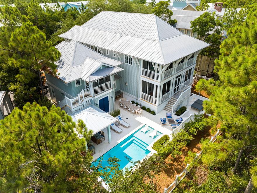 A spacious property, located on an oversized lot that backs up to preserve, featuring a one-of-a-kind pool and outdoor kitchen, 128 Red Cedar Way is a unique opportunity to own a home that is as practical for hosting large families as it is for entertaining.  Unrivaled in value at its price point, this Camp District darling is perfect for making memories.  Comprising 3,866 square feet across two full levels in the main house, with an additional carriage house, the home was thoughtfully conceived and skillfully built in an era of timeless architecture and legacy investment.  With the recent addition of an enhanced outdoor space and pool complex, this is a house that wants for nothing. A first floor open concept plan allows for versatile seating options and quick access to the back yard.  Wolf and SubZero appliances punctuate a chef's kitchen and oversized breakfast bar.  The additional bedroom on the main level, with an en suite bathroom, is helpful in accommodating multigenerational families.  

Upstairs, guests enjoy a junior suite and a bunk-style bedroom, both with private bathrooms.  An expansive master wing offers additional privacy and amenity.  

The garage to this home is attached -something uncommon in the community- allowing for comfortable unloading in all weather.  Its separate carriage house is a retreat unto itself. Boasting its own kitchen and washer/dryer, the apartment is self sufficient.

The home's six porches and balconies expand its living space and give guests a number of options to enjoy the cool afternoon breeze.  Proximity to Camp WaterColor, while easily accessing the neighborhood trails, means the home is convenient to all that WaterColor has to offer.  