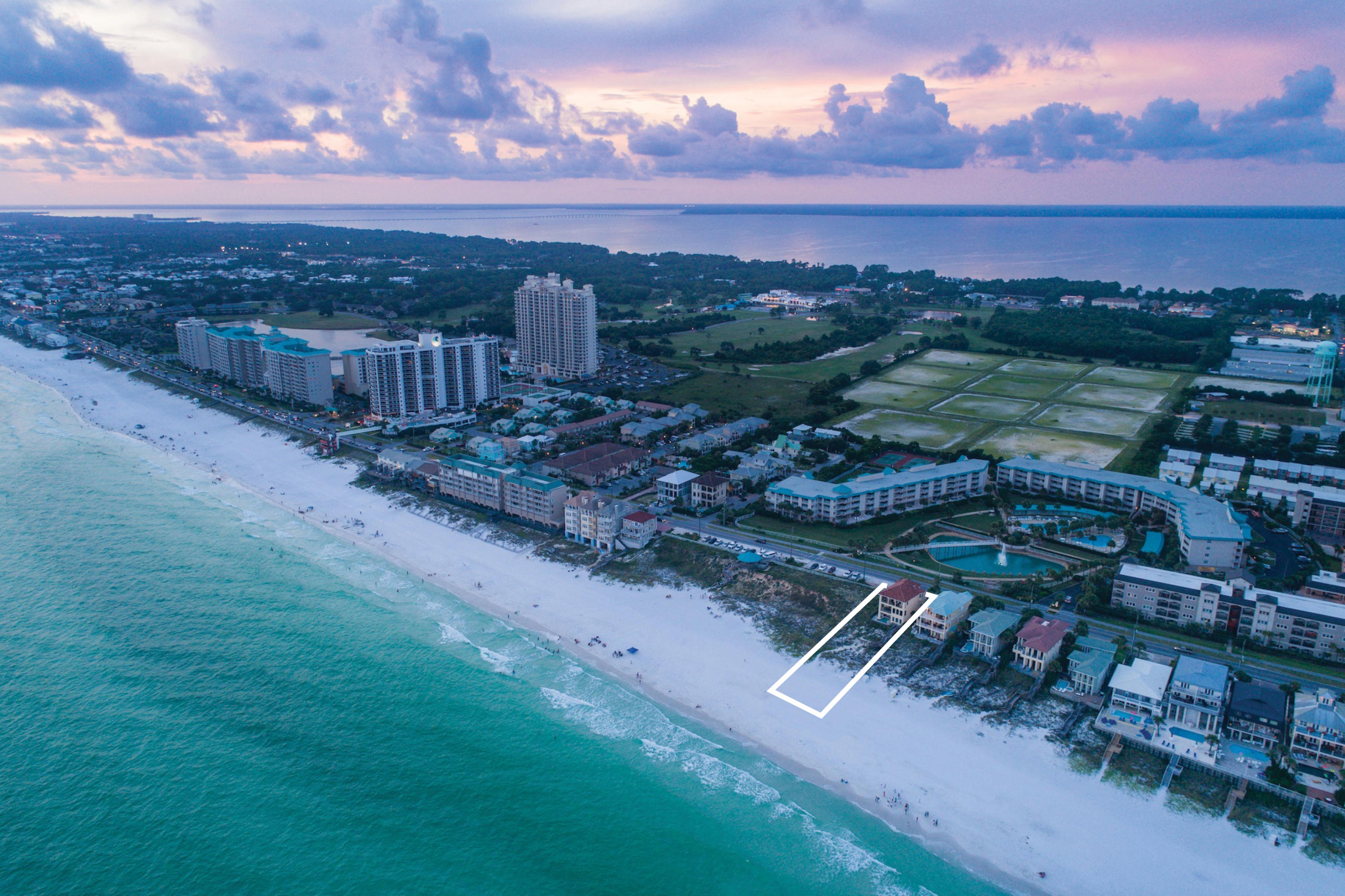 Pristine gulf views framed by floor to ceiling glass define this majestic beachfront retreat prominently situated over 30' above sea level with an unparalleled southwestern orientation yielding endless gulf vistas from each level of this masterful home. This impressive rental machine boasts five full bedroom suites and has been completely remodeled with finely appointed coastal contemporary finishes thoughtfully implemented for optimal rental opportunity and ultimate longevity including the coveted addition of a private gulf pool area. Notable features include an impressive three story vertical footprint accessible by private elevator with a spacious open floor plan designed for legacy living with concrete block and stucco veneer. The first level offers a large two car garage and is