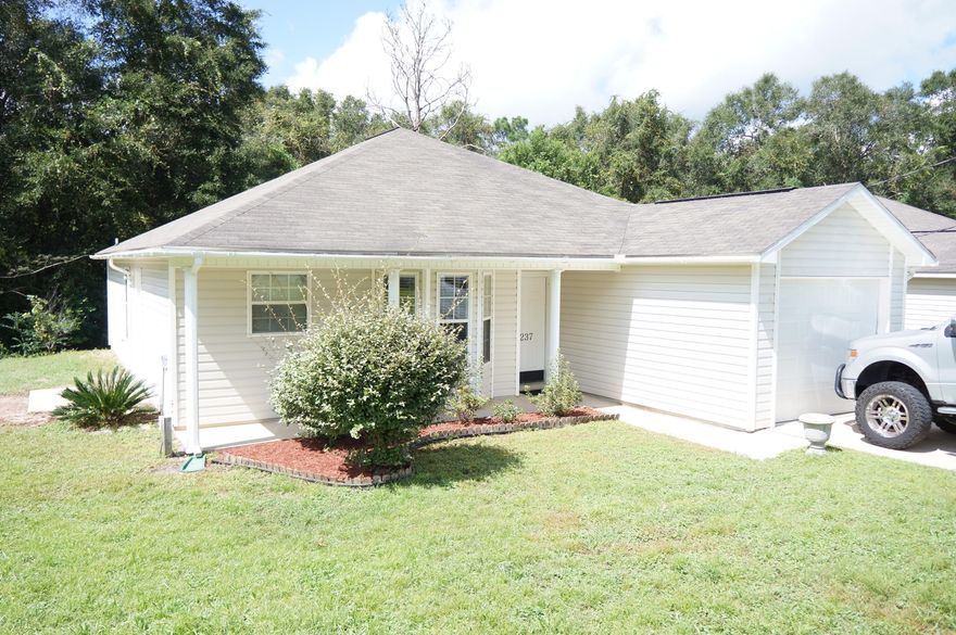 Come see this great MOVE-IN ready home! This adorable patio home has low maintenance vinyl siding, and a nice covered front porch. The home has been freshly painted a neutral grey paint throughout with new carpet in the living room and the bedrooms. Gorgeous new vinyl plank flooring in the kitchen, dining area and baths. All this and a new roof to be installed soon. The large kitchen has plenty of cabinets, pantry and fully equipped with stove, refrigerator, and dishwasher and a cheerful bay window designates the dining area. The vaulted ceiling in the living room gives the home an open spacious feel. Located in the center of Crestview makeing the commute to 7th SFG,  Eglin AFB and the beaches convenient.