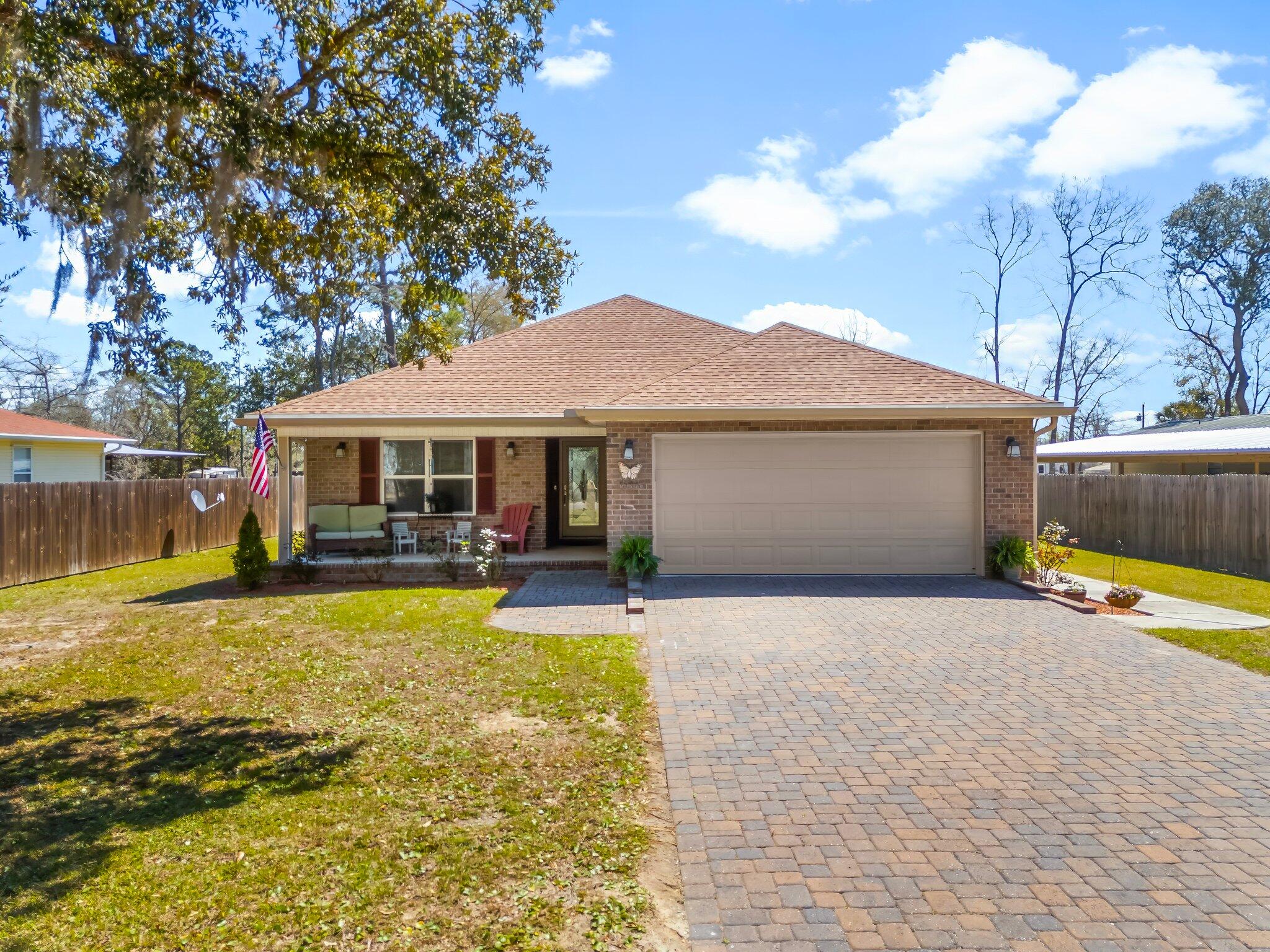 NO HOA in prime Freeport location! Just minutes from the 331 bridge and beautiful 30A beaches, this home is priced to sell.Solid brick construction and a 2 car garage with epoxy flooring enhance this charming ranch. The front porch welcomes you as you enter. High ceilings in the living area add to the spacious feeling. Split bedroom floor plan offers privacy for the primary bedroom, which is an oasis with a large closet, step in shower AND separate tub!The dine-in kitchen can accommodate a 6 person dining table plus guests can visit at the raised granite breakfast bar. The back of the home features a sunroom that opens to a spacious screened porch where you can sit and listen to the boats on Black Creek. Built in 2018, this home is ready for you to move right in and make it yours!