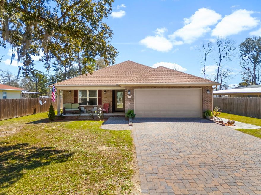 NO HOA in prime Freeport location! Just minutes from the 331 bridge and beautiful 30A beaches, this home is priced to sell.Solid brick construction and a 2 car garage with epoxy flooring enhance this charming ranch. The front porch welcomes you as you enter. High ceilings in the living area add to the spacious feeling. Split bedroom floor plan offers privacy for the primary bedroom, which is an oasis with a large closet, step in shower AND separate tub!The dine-in kitchen can accommodate a 6 person dining table plus guests can visit at the raised granite breakfast bar. The back of the home features a sunroom that opens to a spacious screened porch where you can sit and listen to the boats on Black Creek. Built in 2018, this home is ready for you to move right in and make it yours!
