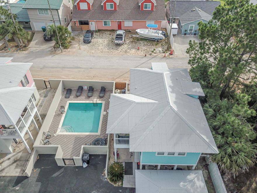 CURRENTLY UNDER CONTRACT, SELLER ACCEPTING BACKUP OFFERWhat an amazing home on the East End of Panama City Beach in the small community of Seaview Villages,only a few blocks from beach access. We love this home for so many reasons! The Beachy decor is very well done ( and the home is being sold furnished and rental ready),All bedrooms have a private bathroom,lovely kitchen with granite countertops,nice floor plan with 2 bedroom & 2 baths on the main level, open kitchen/living/dining area and there is a wonderful Master suite. This home sleeps 10 people easily and will make a wonderful rental property or primary home.This sweet home has a community pool shared with only 8 homes.Not only is the home great ,the location is brilliant!