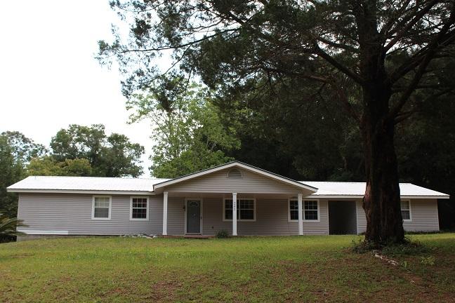 Seller says ''bring me an offer!'' Quiet Country living! 4 bedroom, 2 bath with detached workshop. Family room with stone fireplace. Enclosed 13x28 back porch that could be finished to add an additional 360 S.F. of heated & cooled living space. 1.27 acres. Big back yard with mature hardwoods. Immediate occupancy. Easy to show.