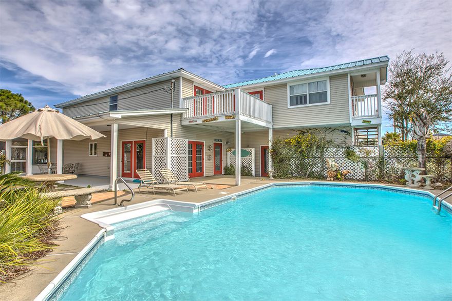 This four-bedroom home offers a great location in Crystal Beach, which places you within walking distance of the emerald waters of the gulf. The two-story home is surrounded by a white picket fence, with a walkway that leads to a wraparound, enclosed porch. Etched glass doors at the entrance open into the living area. The modern kitchen includes stainless steel appliances and bright cabinetry, accented by an ebony black countertop. Double wide arched portals lead into a formal dining room, with expansive views of the salt water pool. A guest bedroom is on the first floor with access to a full hall bath. 

On the second floor, the spacious master bedroom includes two walk-in closets and en suite bathroom with a walk-in shower and soaking tub. French doors lead out of the master onto a breezy balcony overlooking the pool. Another guest bedroom is on the second floor with a seating area and bathroom. 

Above the two-car garage is a studio apartment with a private entry featuring a kitchenette, bedroom, a walk-in closet and a full bathroom.

There are side by side washer and dryer units in a downstairs closet in the main house, as well as a stacked washer and dryer unit in the studio apartment. A whole home generator is also included. This home was built before the set-back rules, so the wraparound porch can legally be enclosed to add to the square footage. There are three HVAC units, one for each floor and one for the apartment over the garage. Outside, there is a mature satsuma tree with delicious fruit each fall. There is also a warm water shower by the pool.



Location is key, and this home is within golf cart distance to both the beach and multiple shopping and dining centers, including the Destin Commons, Crystal Beach Plaza and the Shoppes at Paradise Isle.