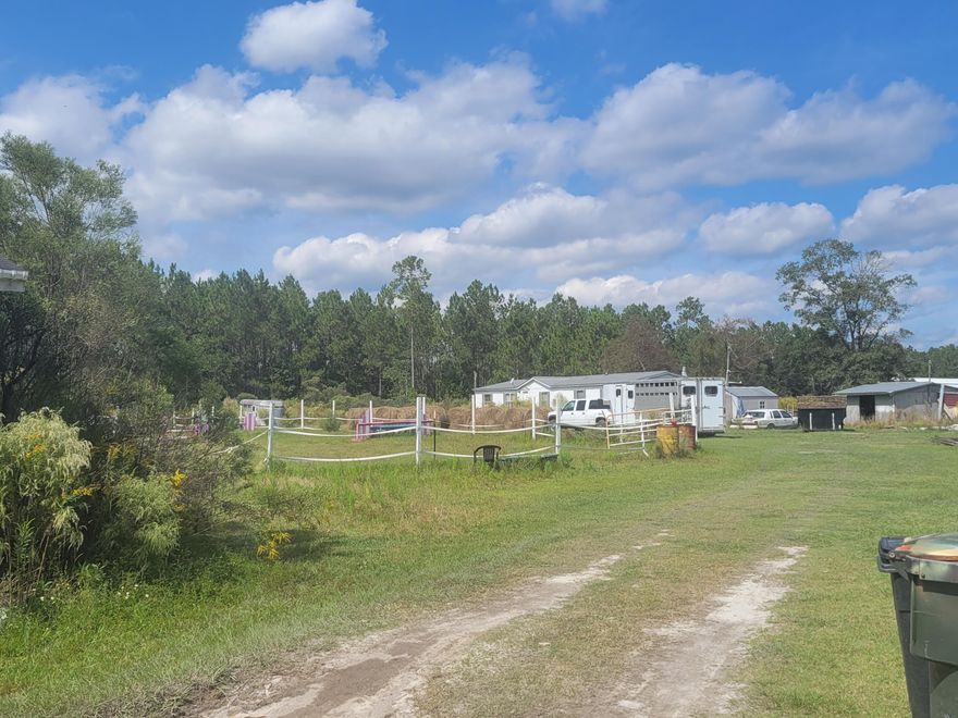 Horses will love this appx. 19 acres on Hwy 20 E.  Easy access to Panama City or South Walton Beaches in very little time.  Property has been used for raising and stabling horses.  Home is a fixer-upper 4-5 bedroom 3 bath 2002 manufactured home also has a second manufactured home on the front of the property, could be used for storage.  Stables/Barns on the property with water lines and electricity.  No HOA. Financing is not an option since home needs repairs.