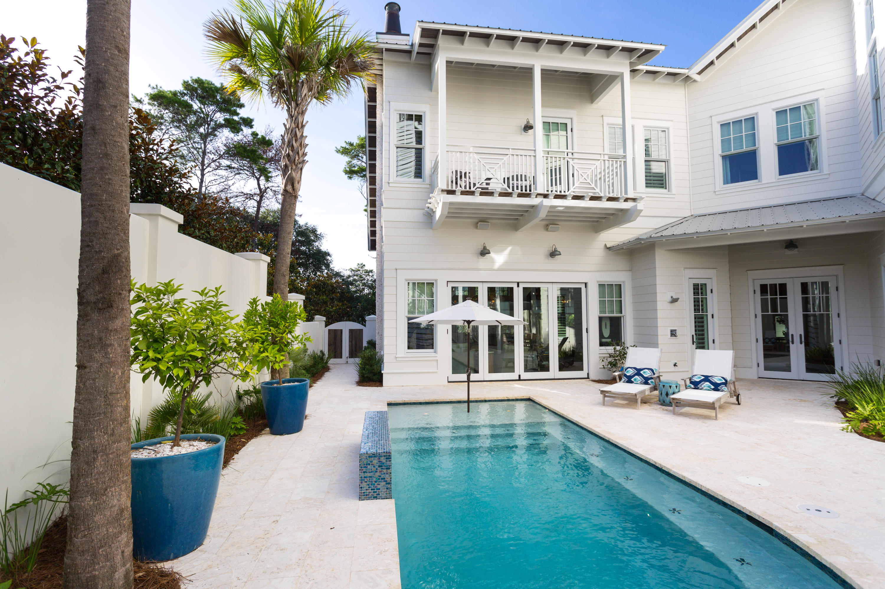 A true sanctuary in a highly coveted location in Old Seagrove, this 5BR/6.5BA Gulf view retreat was custom-built by Alex Rice of Old Seagrove Homes. Private courtyard walls surrounding an outdoor oasis with a gunite saltwater pool, a fire pit and a grilling and dining area creates a peaceful, secluded ambiance yet the beach, Seaside and WaterColor are just steps away. Every detail of this home has been meticulously selected and the quality of materials is evident from the moment you enter the gorgeous Mahogany front door. A chic coastal style creates a bright and sunny vibe where pecky cypress accents contrast with white walls and carefully chosen design features such as a grand tabby shell fireplace in the living room.